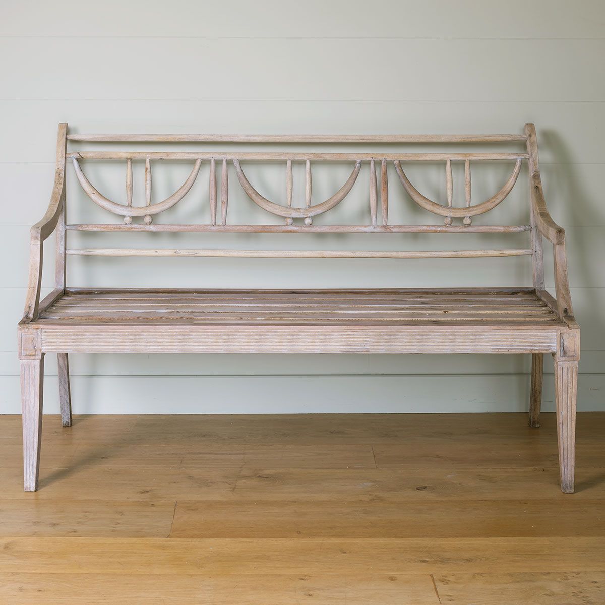 Ex-display Gustavian bench in pale painted wood on a boarded floor