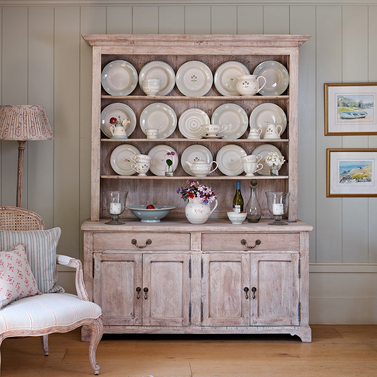 Kitchen dresser stacked with cream pottery and plates