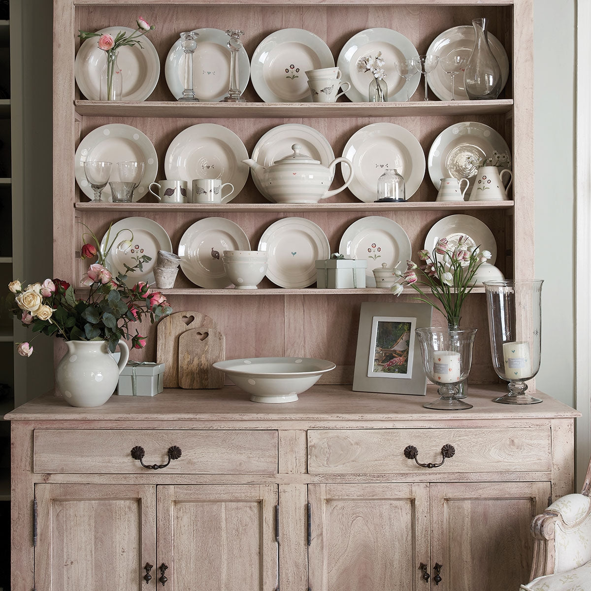 Painted kitchen dresser displaying jugs, plates and bowls