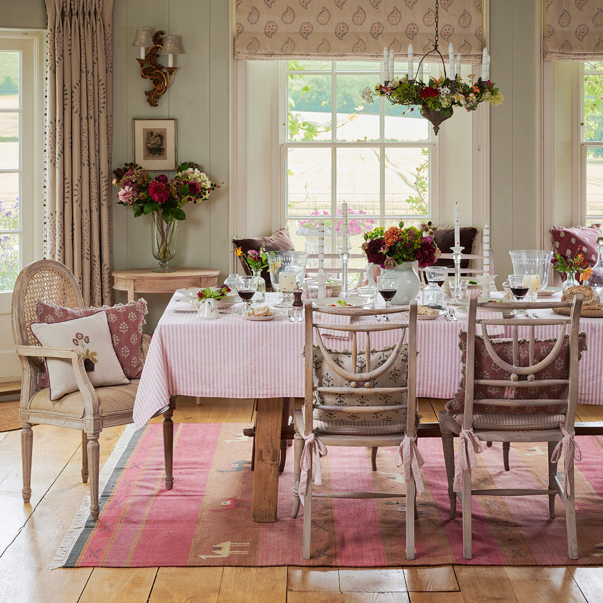 Camels and Stripes kilim beneath a dining table laid in pink