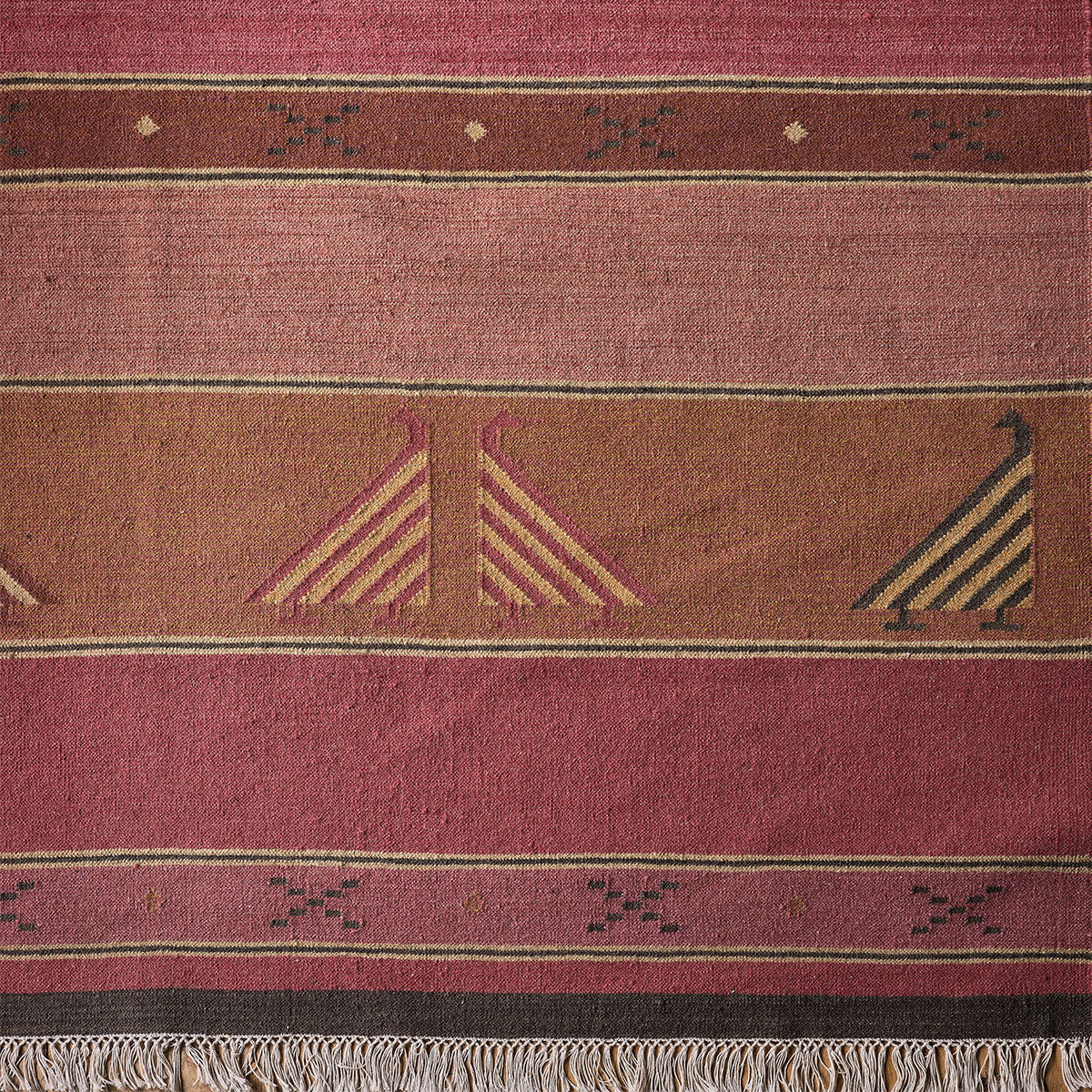 Indian Bird Rose kilim close up, red stripes with woven bird motifs