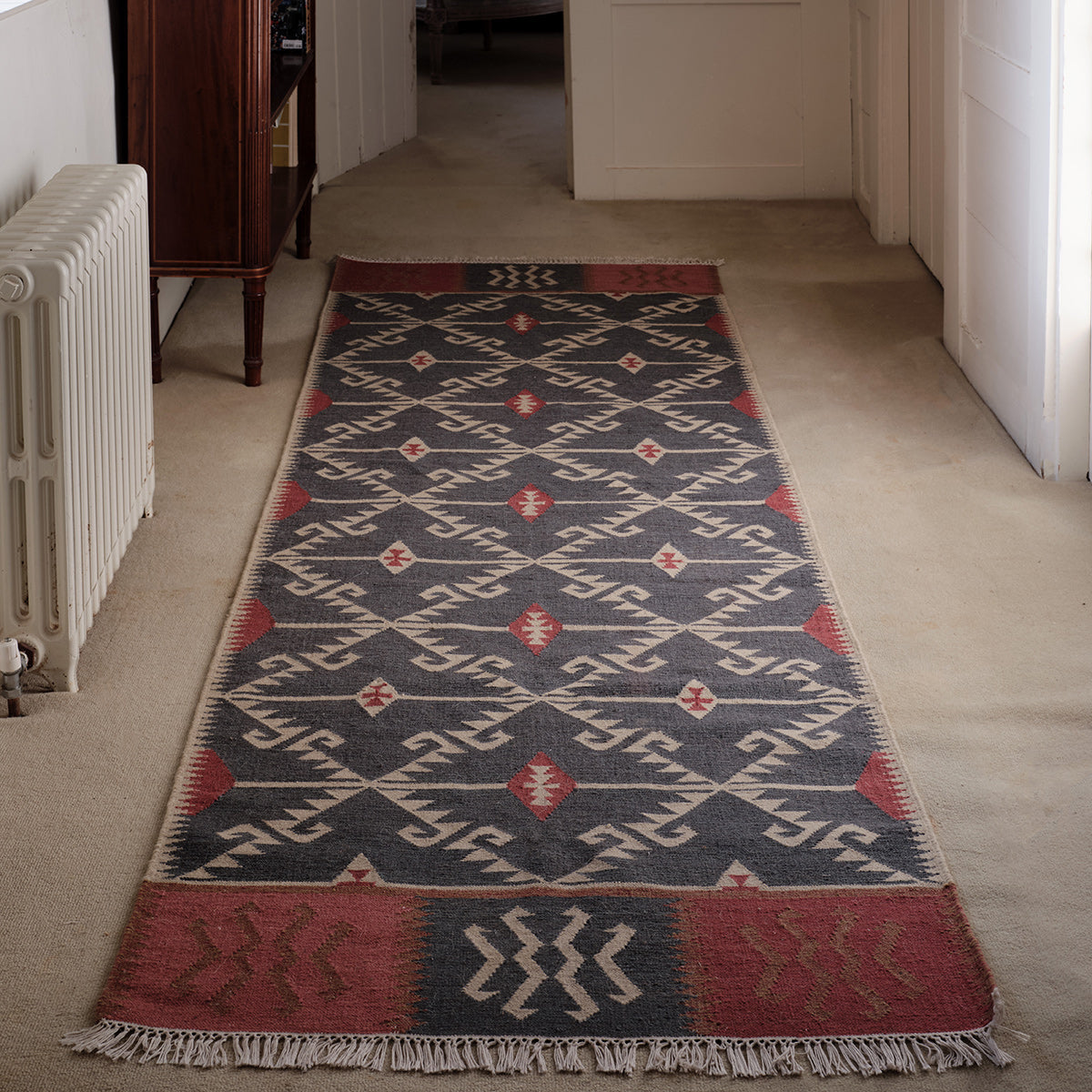 Blue Ivory Serrif wool kilim runner laid along a hallway