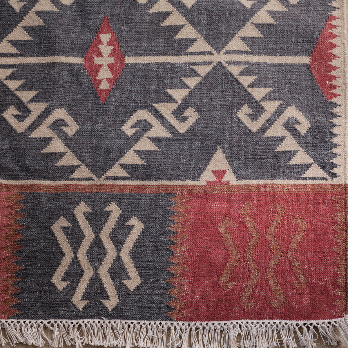 Close view of the Blue Ivory Serrif wool kilim weave and fringe