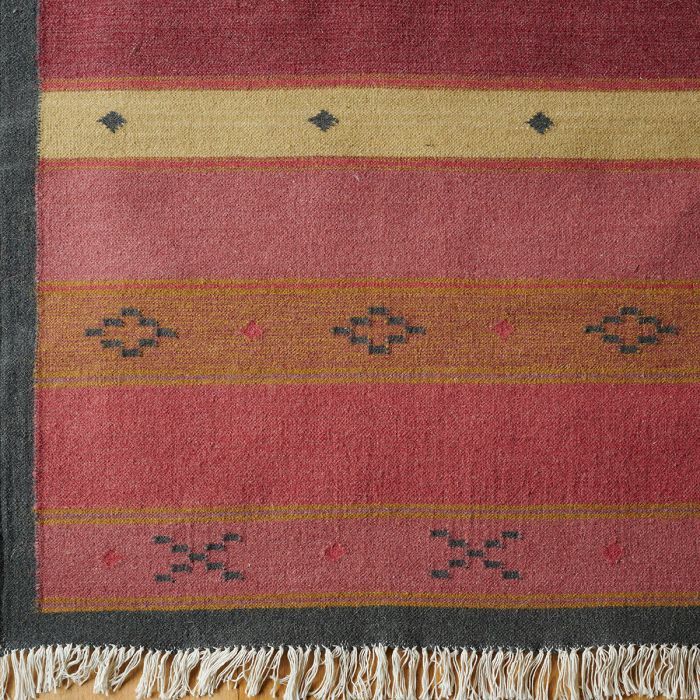 Damson Jaisalmer Stripe wool kilim shown flat in red, gold and charcoal