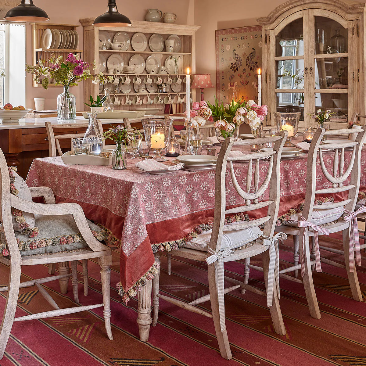 Megha and velvet tablecloth dressing a long table in a candlelit dining room