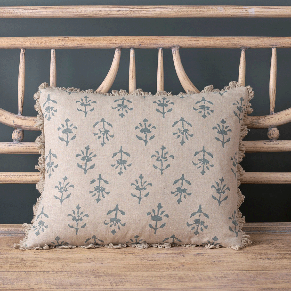 Marine Blue Moonflower linen cushion with fringed trim on a bench