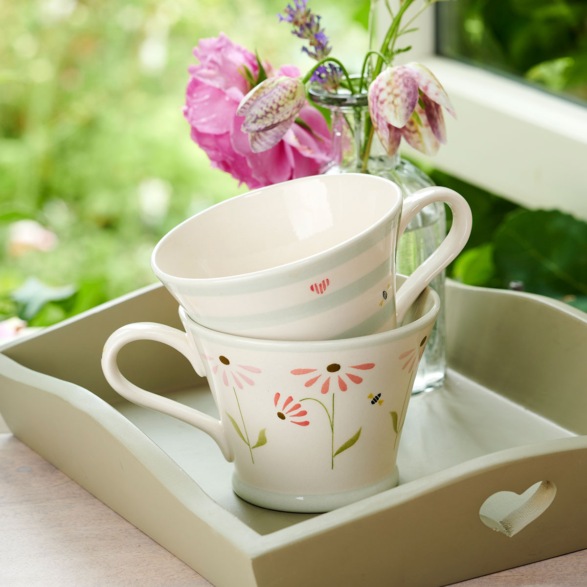 Echinacea conical mugs on a painted tray with sweet peas outdoors