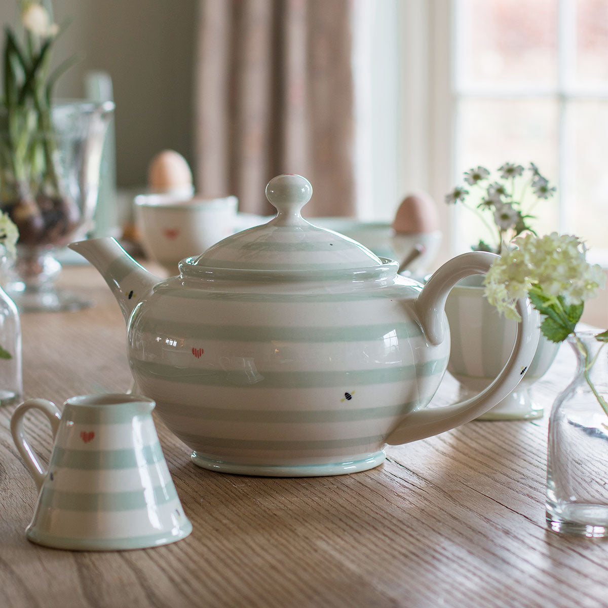 Honey Bees teapot with jug and cups at a sunlit window