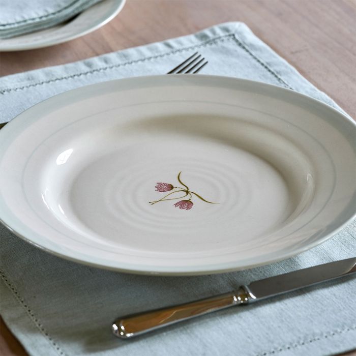 Fritillary dinner plate on a linen napkin with cutlery alongside