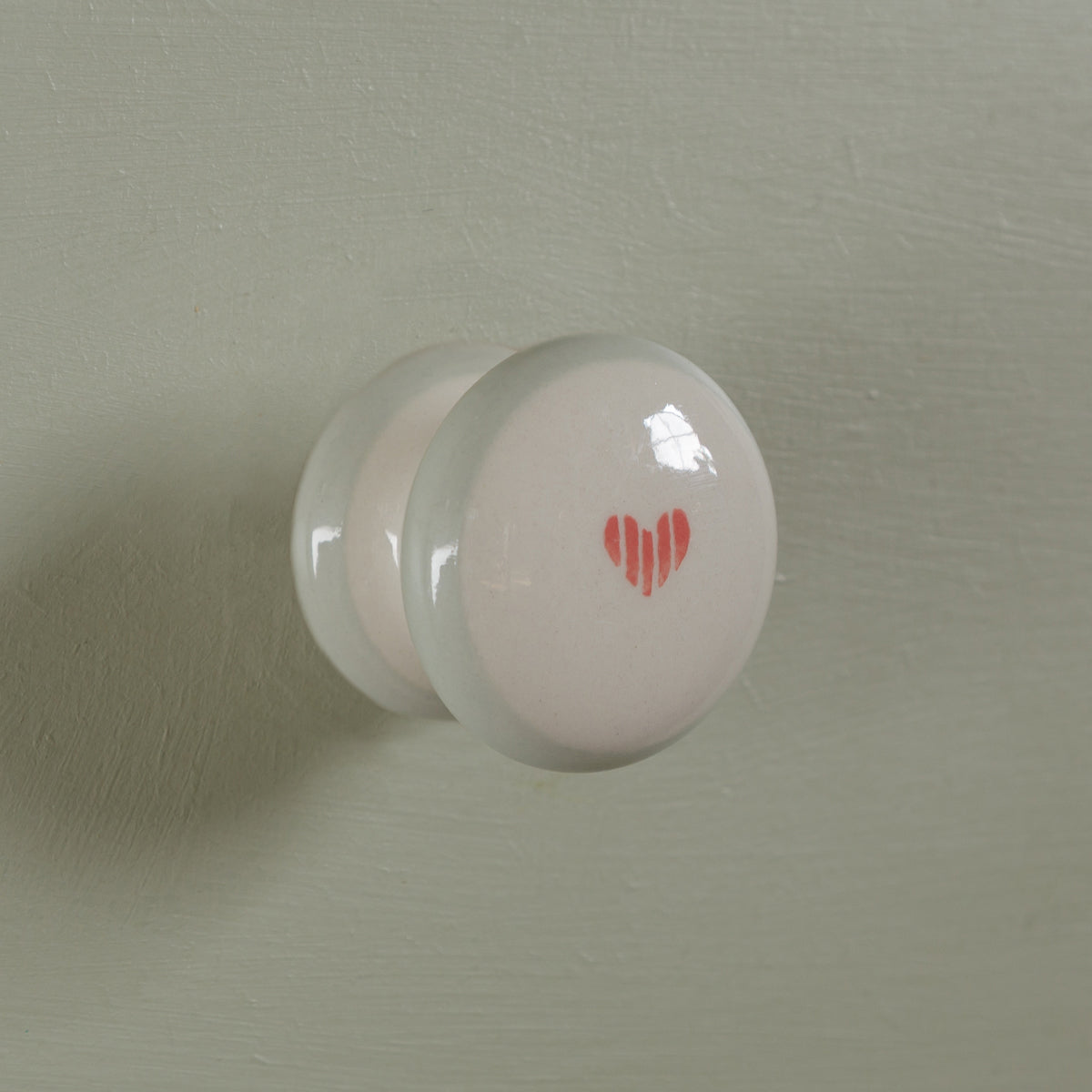 Anya hand-painted cupboard knob with a small red heart
