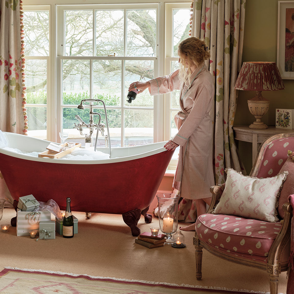 Pink stripe cotton bath robe worn beside a red roll-top bath