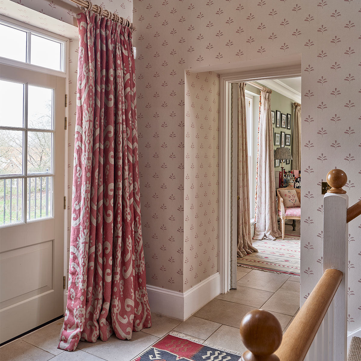 Sacha linen curtains in a hallway with patterned wallpaper beyond