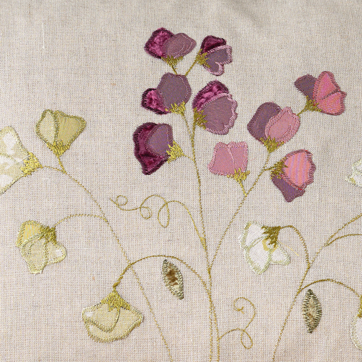 Embroidered sweet peas in mauve and cream stitched on natural linen