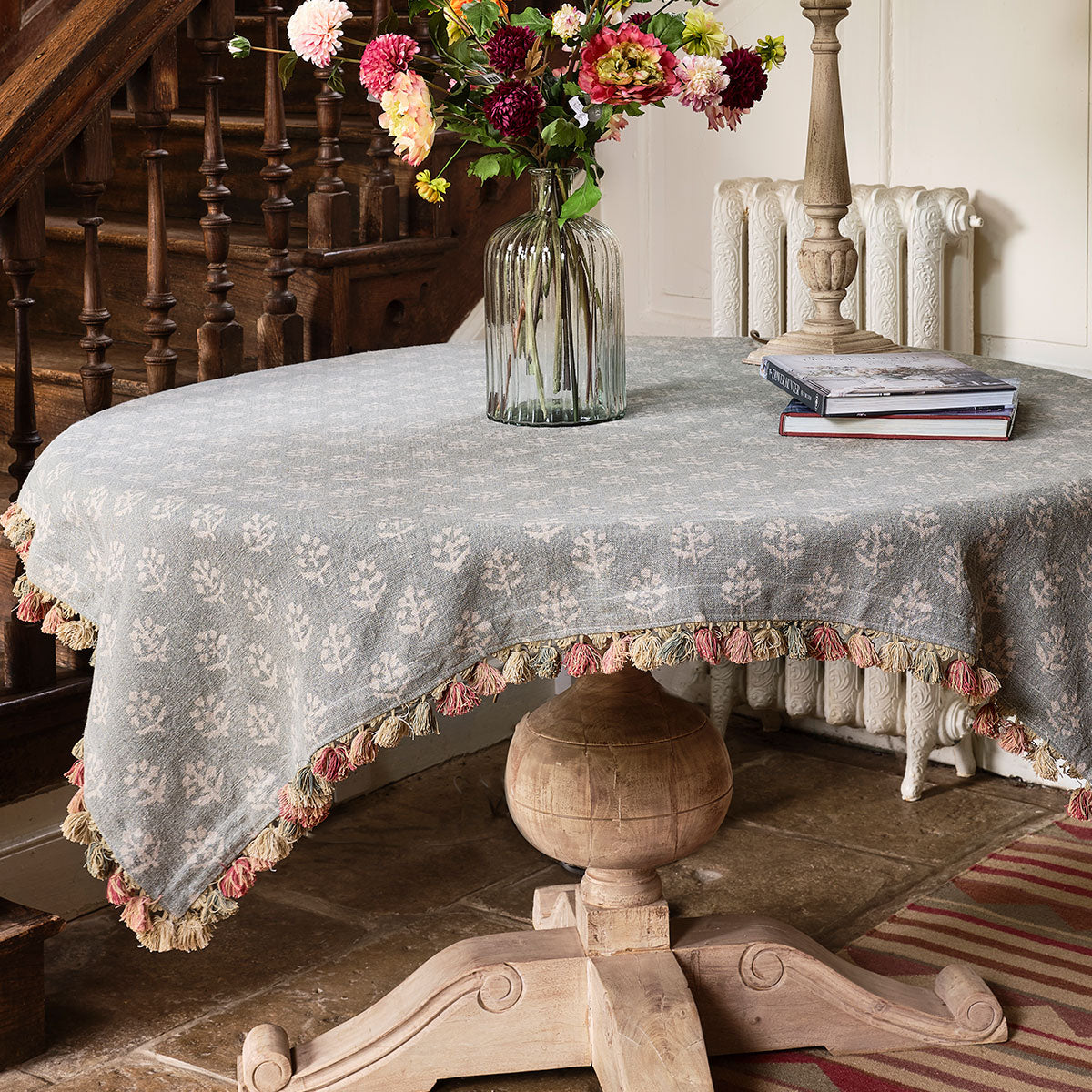 Smokey Blue Megha rustic linen tablecloth with tassels on a round table