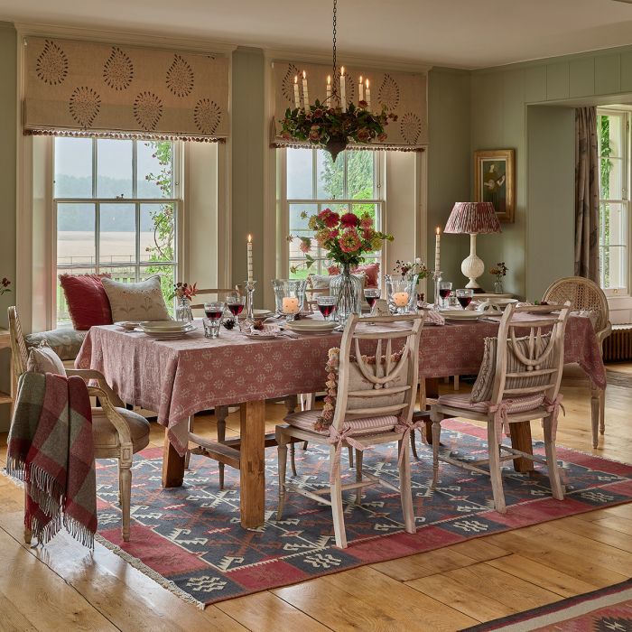Red Earth Megha tablecloth in a dining room above a kilim rug